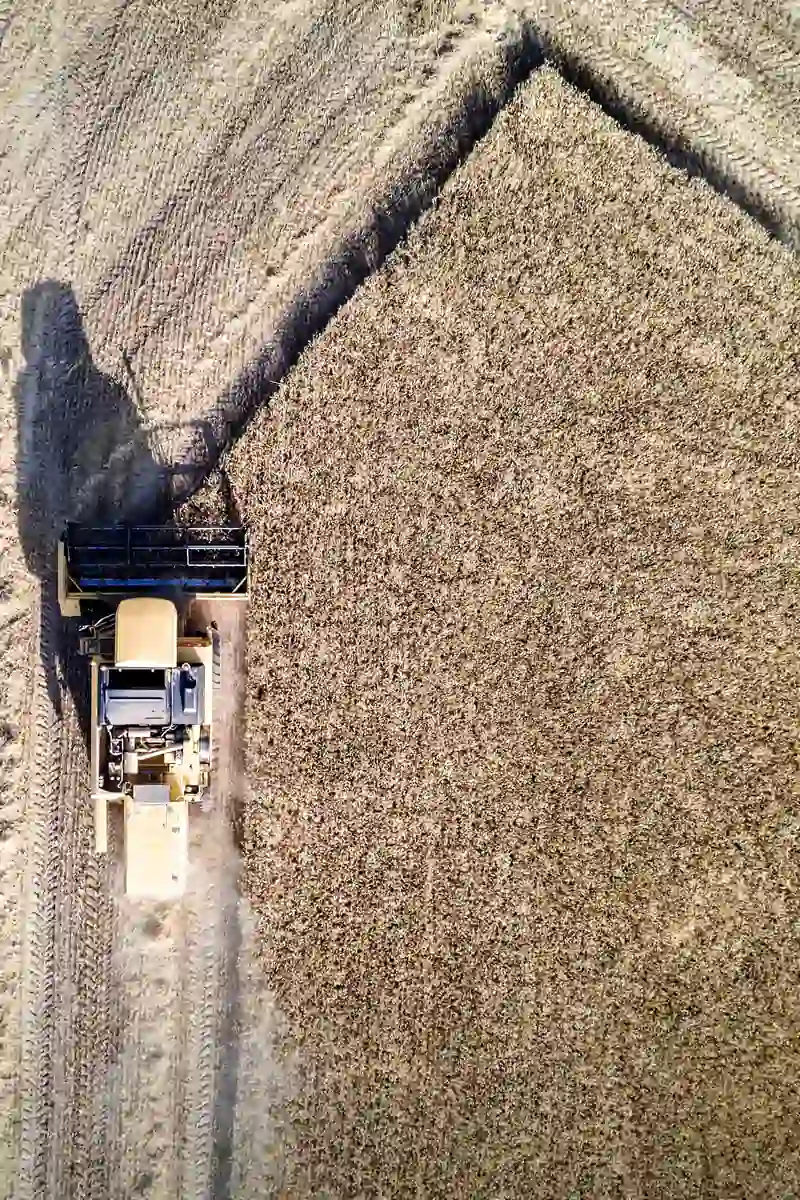 A combine harvester cutting a wheat field, seen from above